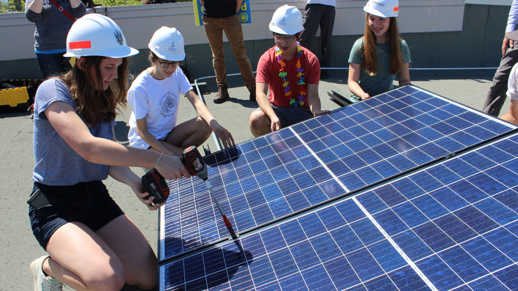 Students learn about solar panel installation and benefits in their district.